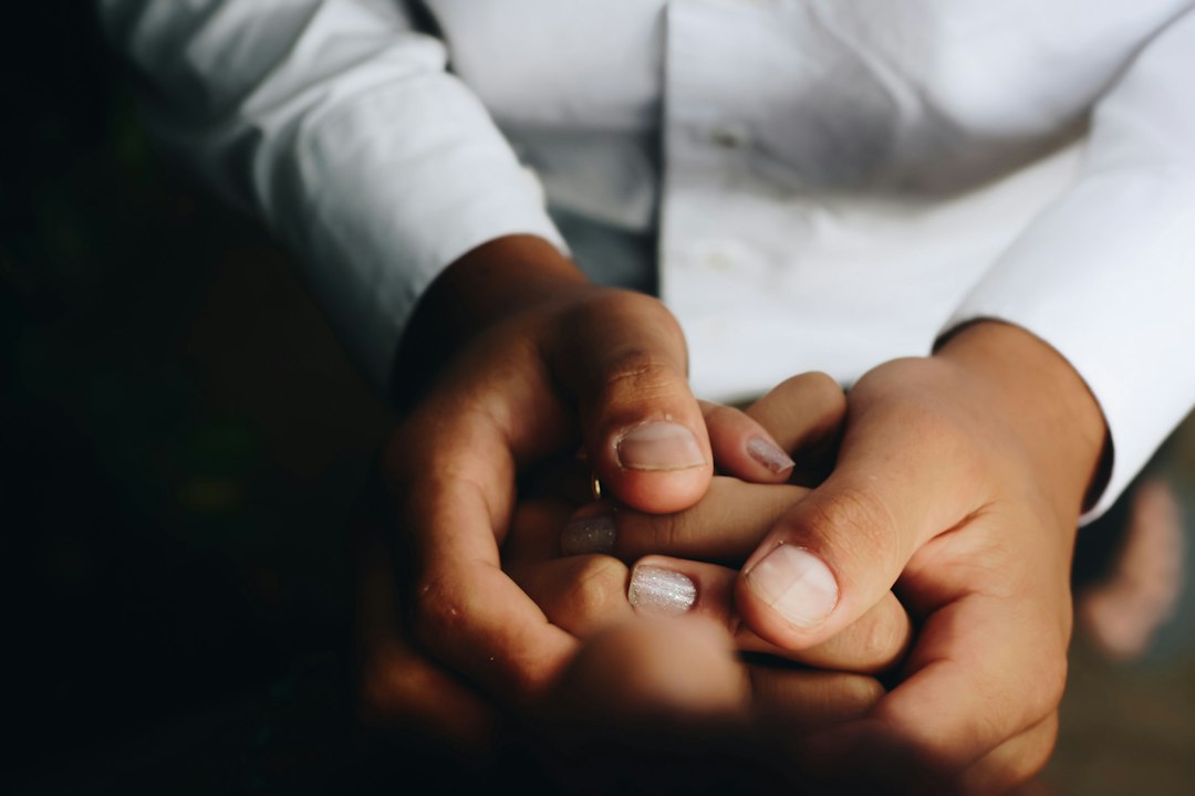 Illustrative stock photograph: two people holding hands