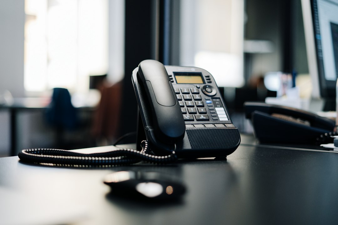Illustrative stock photograph: a telephone on a desk