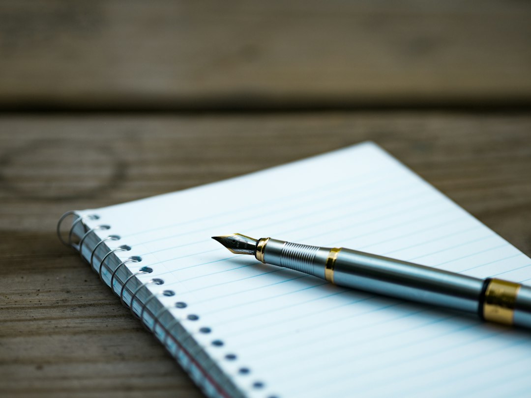 Illustrative stock photograph: a notebook and pen